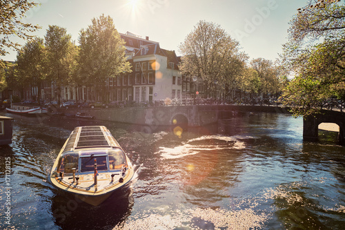 Canvas Print Amsterdam canal with tourist boat