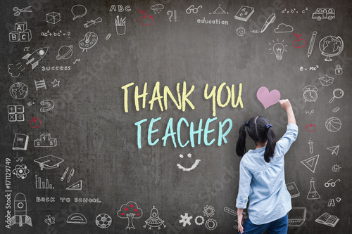Thank You Teacher greeting for World teacher's day concept with school student back view drawing doodle of of learning education graphic freehand illustration icon on black chalkboard photo