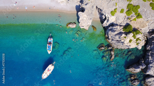 August 2017: Aerial drone photo of paradise beach of Traganou with small caves and turquoise clear waters, Rhodes island, Dodecanese, Aegean, Greece photo