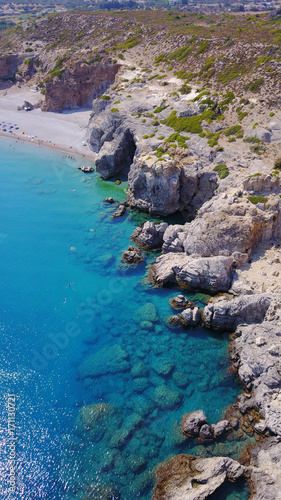 August 2017: Aerial drone photo of paradise beach of Traganou with small caves and turquoise clear waters, Rhodes island, Dodecanese, Aegean, Greece © aerial-drone