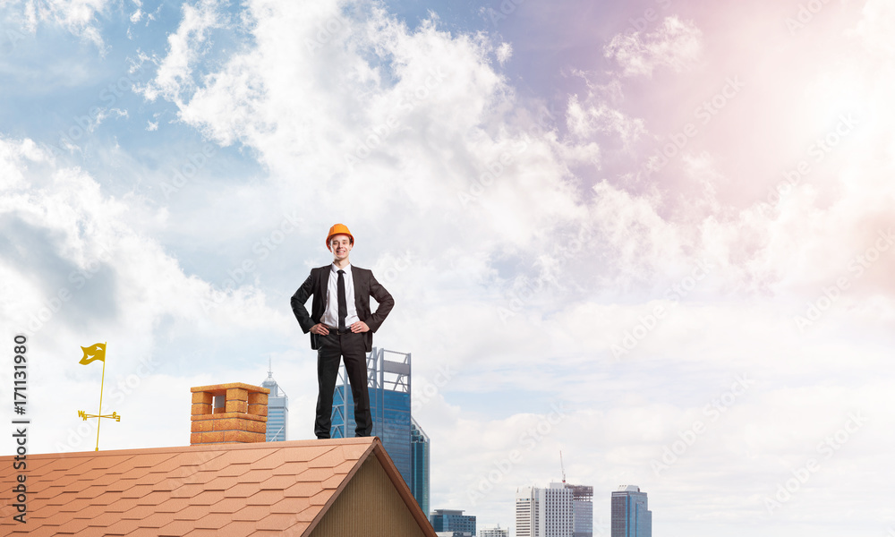 Engineer man standing on roof and looking away. Mixed media Engineer man standing on roof and looking away. Mixed media