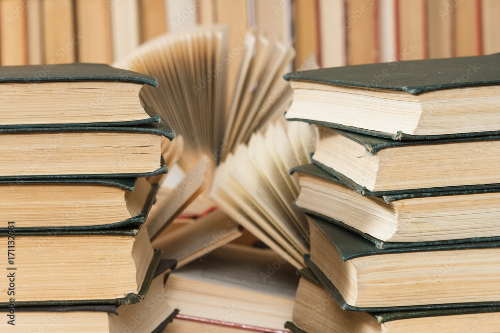 Fototapeta premium Lot of books on the table in the library