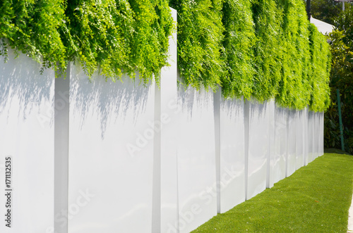 white fence with a green grass above