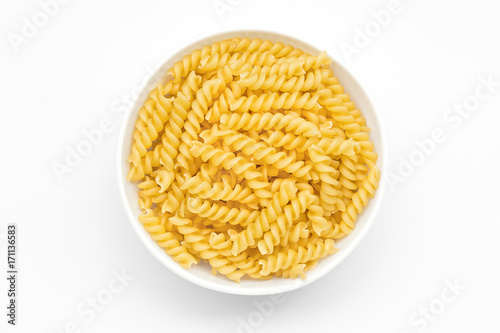 Pasta spiral or fusilli close-up in white bowl,  white background photo