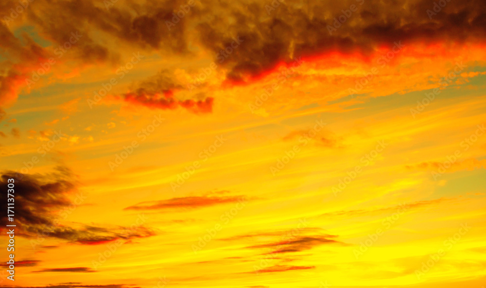 Obraz premium Photo of orange sunset with dark clouds on sky