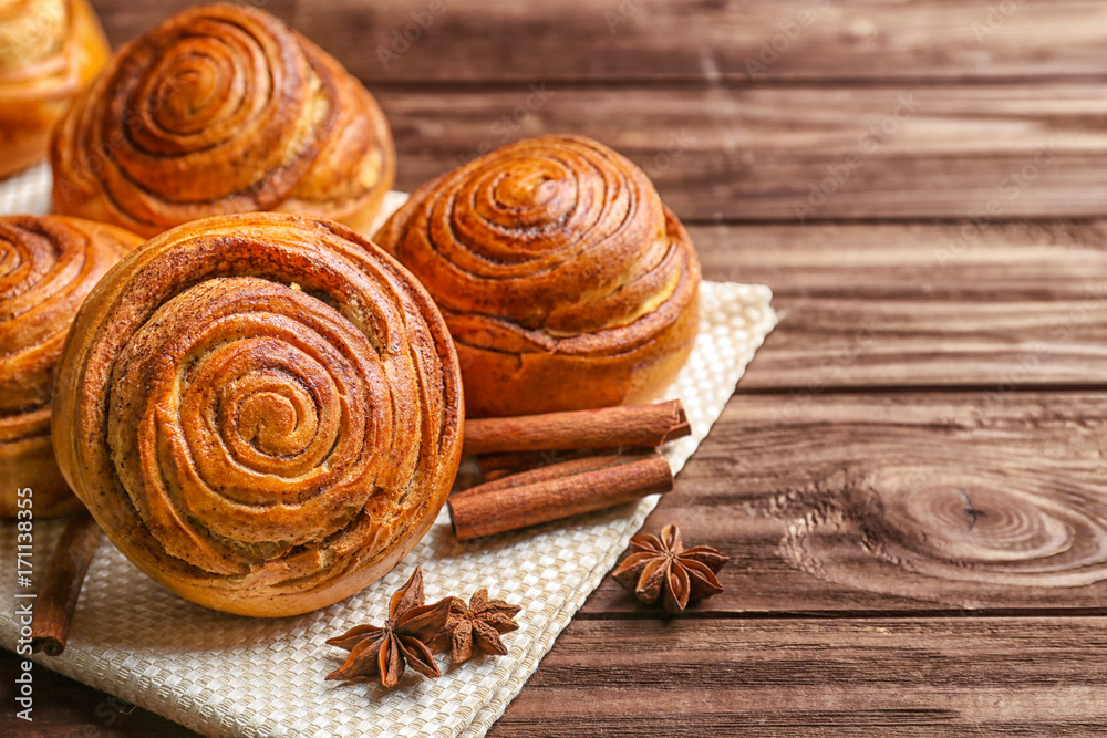 Sweet cinnamon rolls on wooden table Sweet cinnamon rolls on wooden table