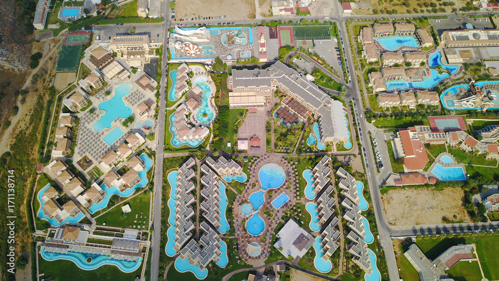 Naklejka premium August 2017: Aerial drone photo of famous pools and 5 star resorts - hotels at small village of Kolympia bay, Rhodes island, Aegean, Dodecanese, Greece