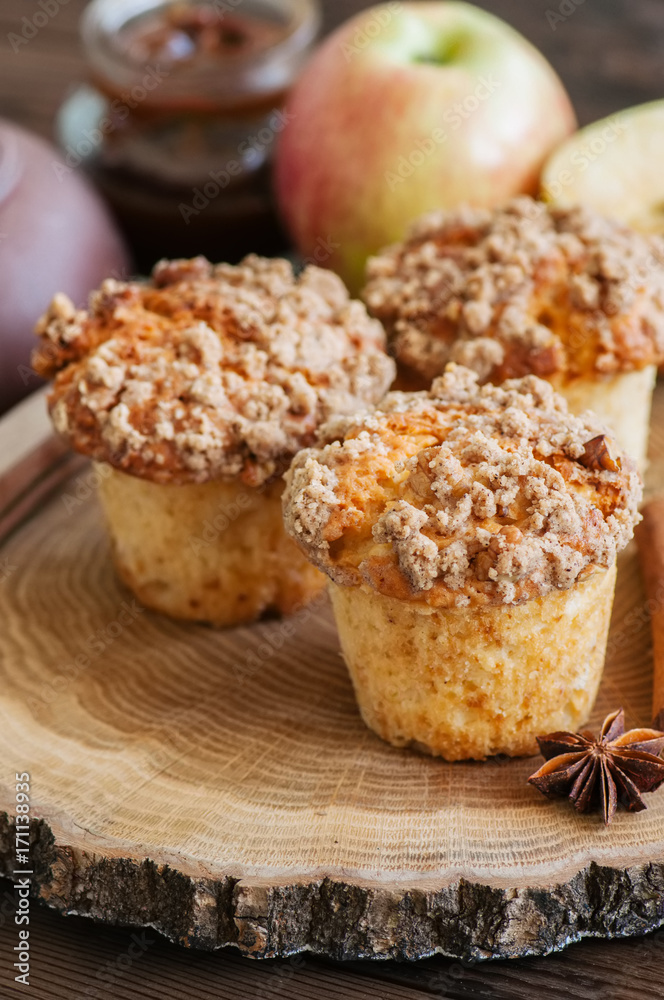 Apple cinnamon streusel muffins on a wooden board. Wooden background.