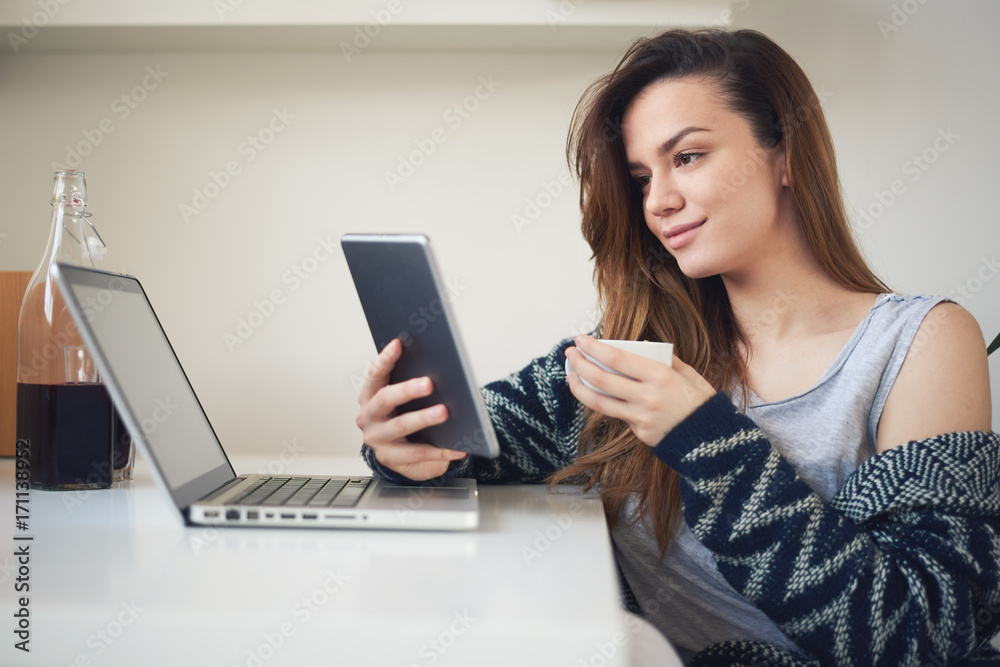 Student drinking coffee and using tablet in the morning Student drinking coffee and using tablet in the morning