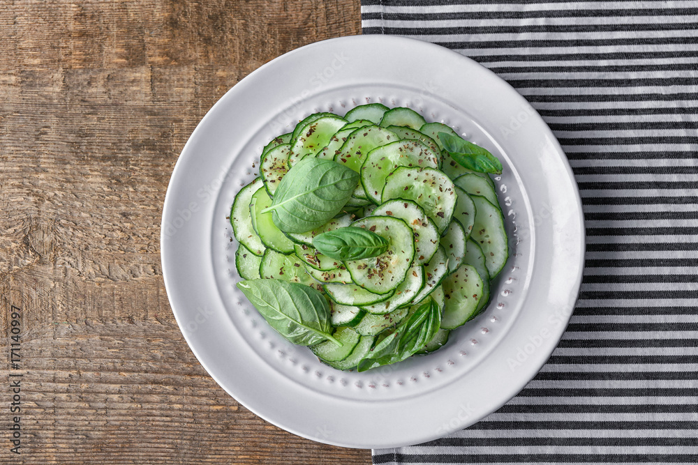 Cucumber salad in plate on table Cucumber salad in plate on table