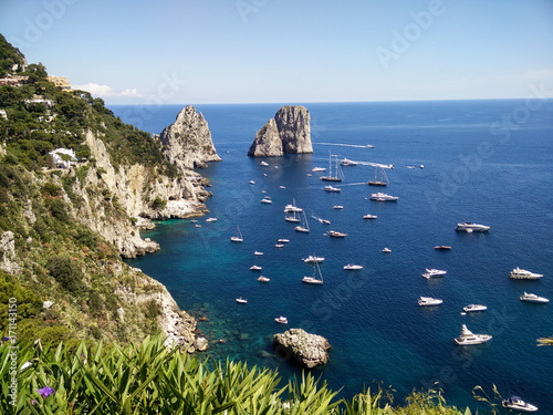 Great view at Capri coastline with boats in the sea