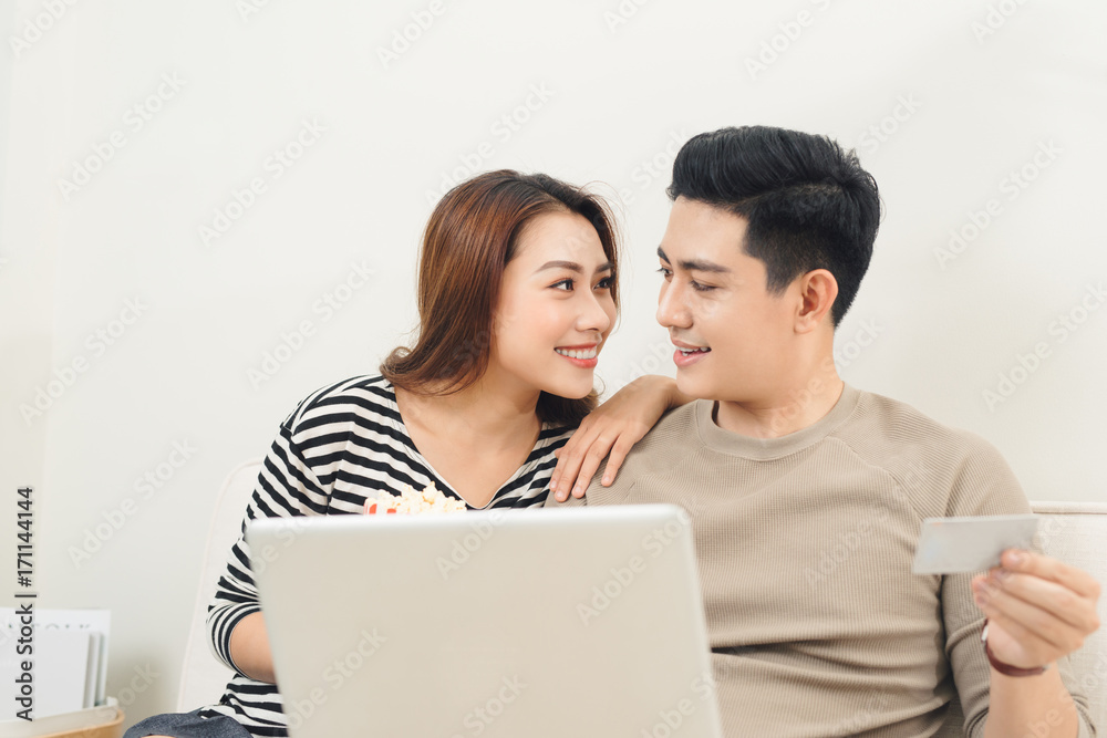 Young asian couple payment online using laptop and credit card Young asian couple payment online using laptop and credit card