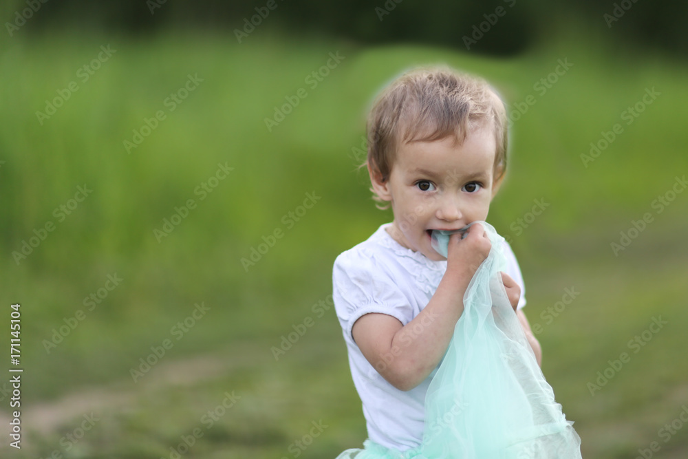 Girl Toddler Playing On Green Glade, Copy Space Girl Toddler Playing On Green Glade, Copy Space