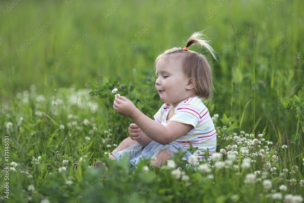 girl Toddler with a funny tail on green glade girl Toddler with a funny tail on green glade