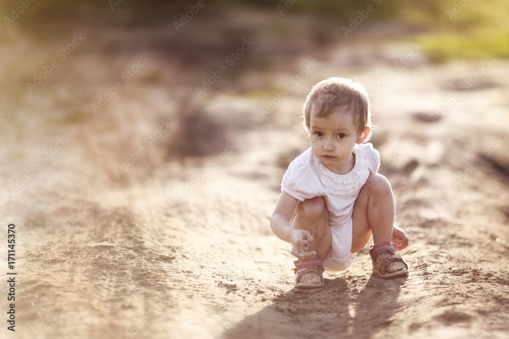 funny girl Toddler baby sitting on the road funny girl Toddler baby sitting on the road