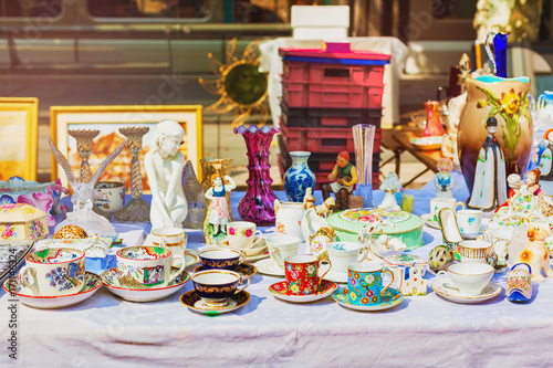 Old cups at flea market. Porcelain china mugs. Tea and coffee set.