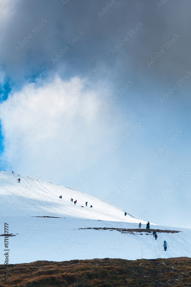 Tourists climbs for camping to the snow-capped mountain top. Concept theme: nature, weather, climbing, tourism, extreme, healthy lifestyle, adventures. Unrecognizable faces. Tourists climbs for camping to the snow-capped mountain top. Concept theme: nature, weather, climbing, tourism, extreme, healthy lifestyle, adventures. Unrecognizable faces.
