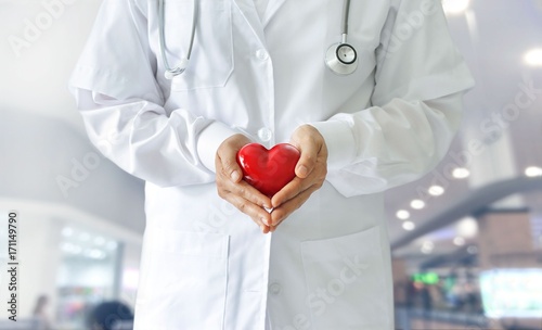 Medicine doctor holding red heart shape in hands, medical technology
