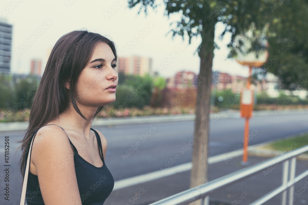 Fototapeta premium Young woman posing in an urban context