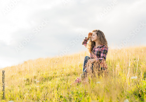 Yound girl on peak mountain with perfect view.