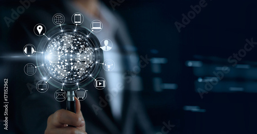 Businessman holding magnifying glass, search payments online shopping and icon customer network connection on screen, m-banking and omni channel photo