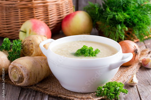 Parsnip soup with parsley and vegetables photo