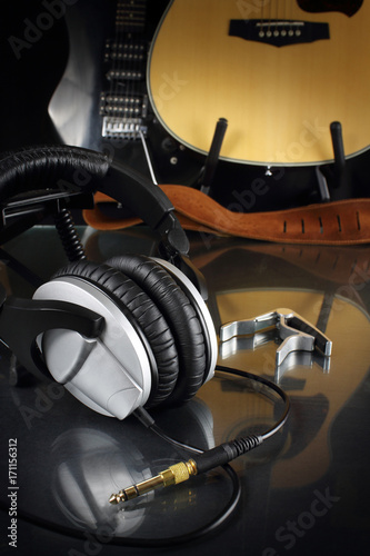 Studio earphones against the background of guitars