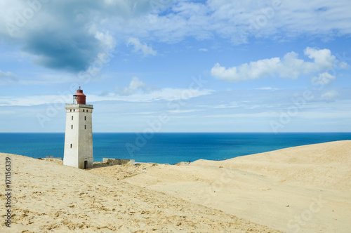 Fototapeta Lighthouse Rubjerg Knude and sand dunes at the danish North Sea coast, vintage s