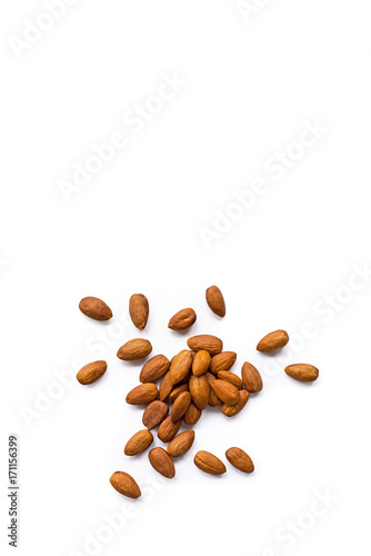 beautiful pile of roasted organic almonds with the peel isolated on a white background. Vertical composition. Top view