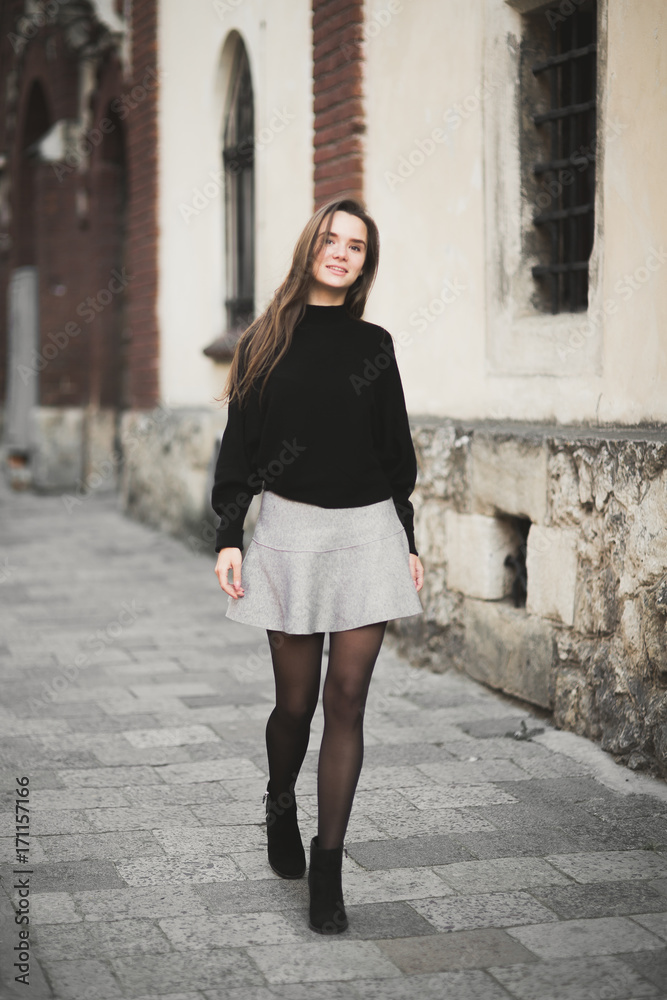 Fashion woman portrait of young pretty trendy girl posing at the city in Europe Fashion woman portrait of young pretty trendy girl posing at the city in Europe
