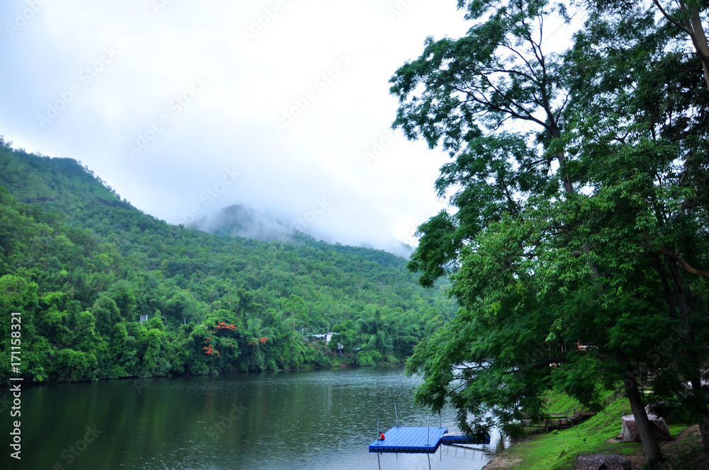 Fototapeta premium Camping area along side Khwae Yai River at Erawan waterfall - Kanchanaburi, Thailand