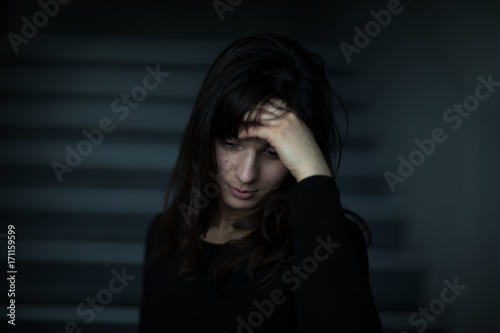 Young woman suffering from severe depression/anxiety (shallow DOF; color toned image)