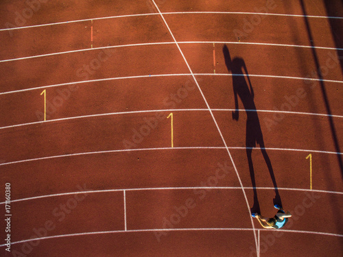 Shot of a young male athlete training on a race track. Sprinter running on athletics tracks.. © lightpoet