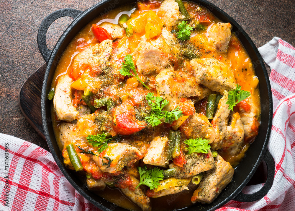 Stewed pork with vegetables in tomato sauce. Stewed pork with vegetables in tomato sauce.