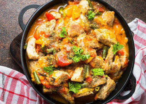 Stewed pork with vegetables in tomato sauce.