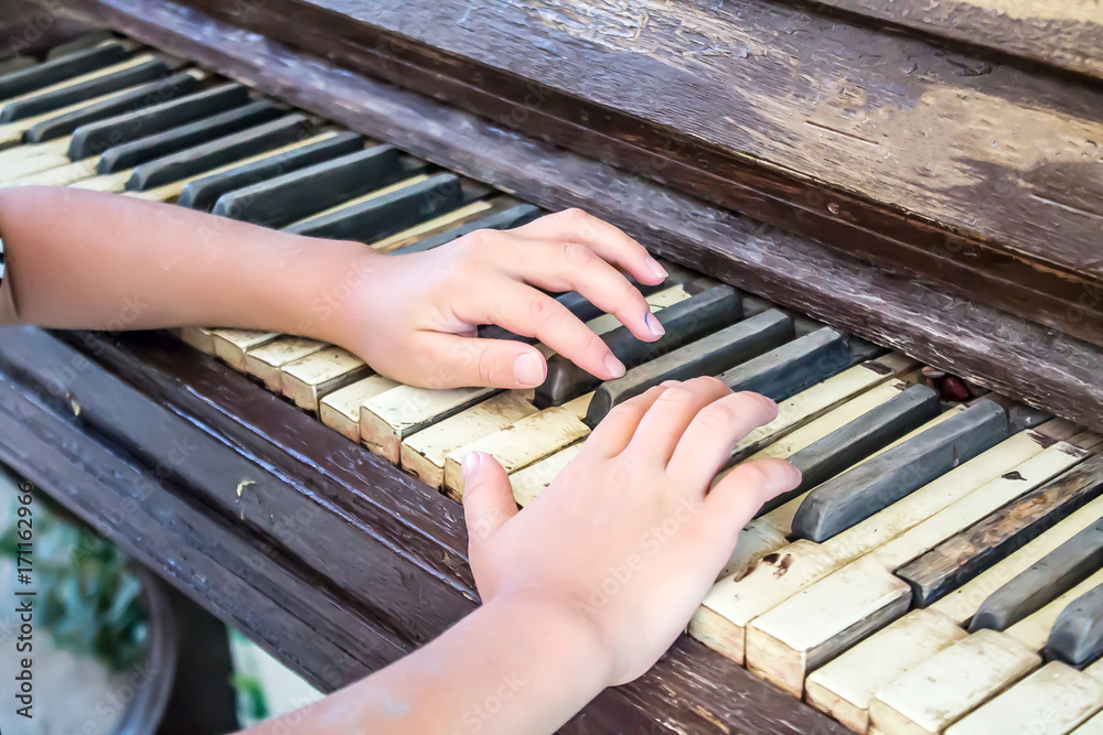 Hands on an old piano