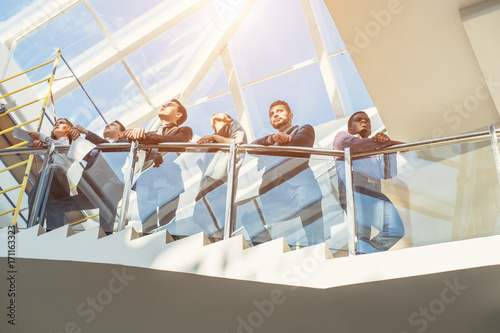 group of business people standing by stairway photo