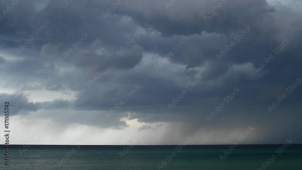 Taymlaps. Storm clouds with rain and lightning over the ocean run Taymlaps. Storm clouds with rain and lightning over the ocean run