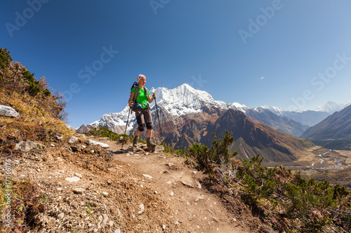 Hiker is climbig to Manaslu base camp in highlands of Himalayas on Manaslu circuit