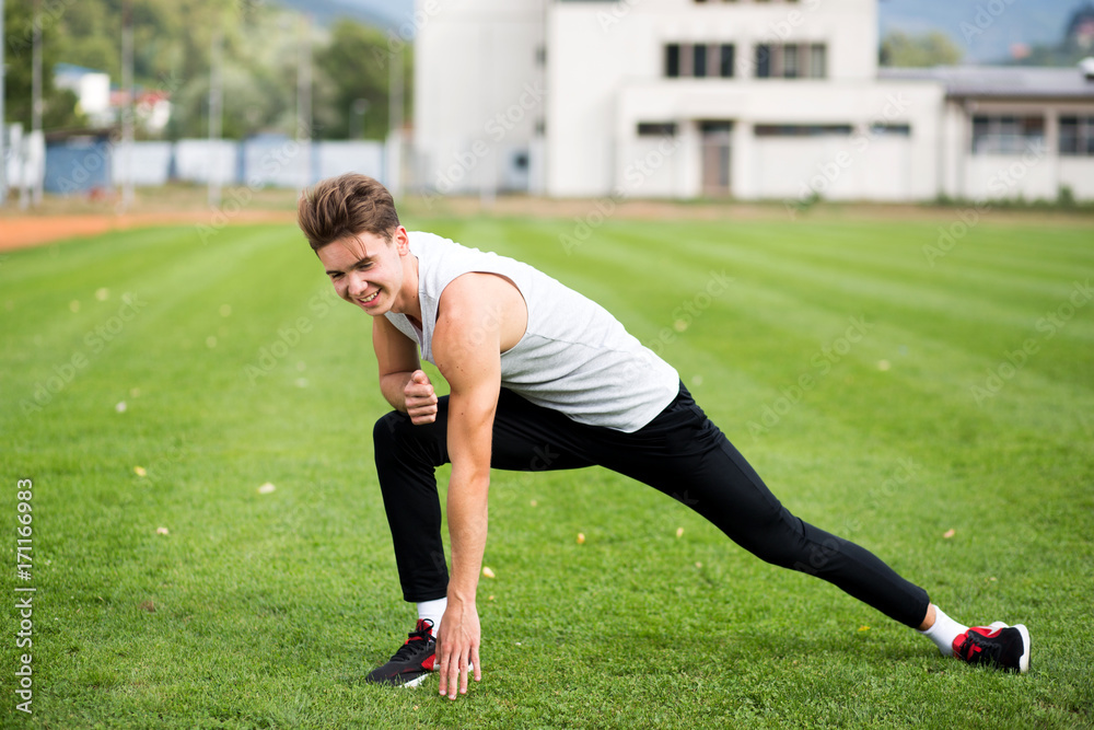 Young caucasian boy training outdoor. Sport and muscle concept Young caucasian boy training outdoor. Sport and muscle concept