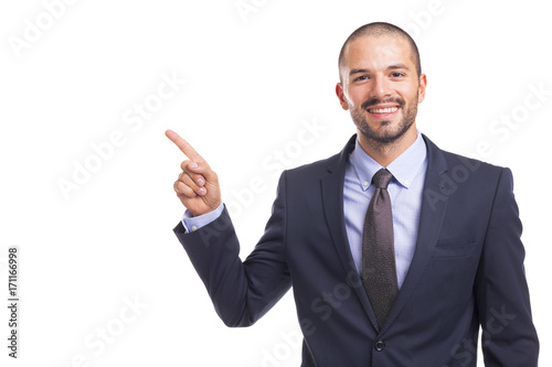 Handsome businessman pointing finger at copyspace, isolated on a white background
