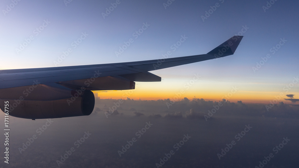 Sunset and Clouds Viewed from the Window of a Modern Airliner Sunset and Clouds Viewed from the Window of a Modern Airliner