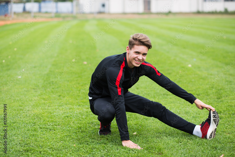 Fototapeta premium Young caucasian boy training outdoor. Sport and muscle concept