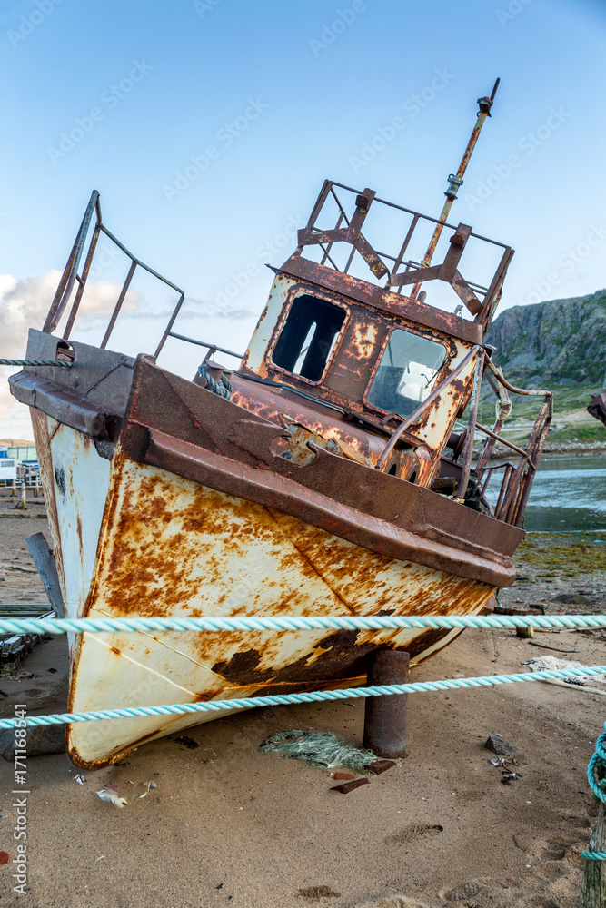 an abandoned rusty ship on a sandy beach an abandoned rusty ship on a sandy beach