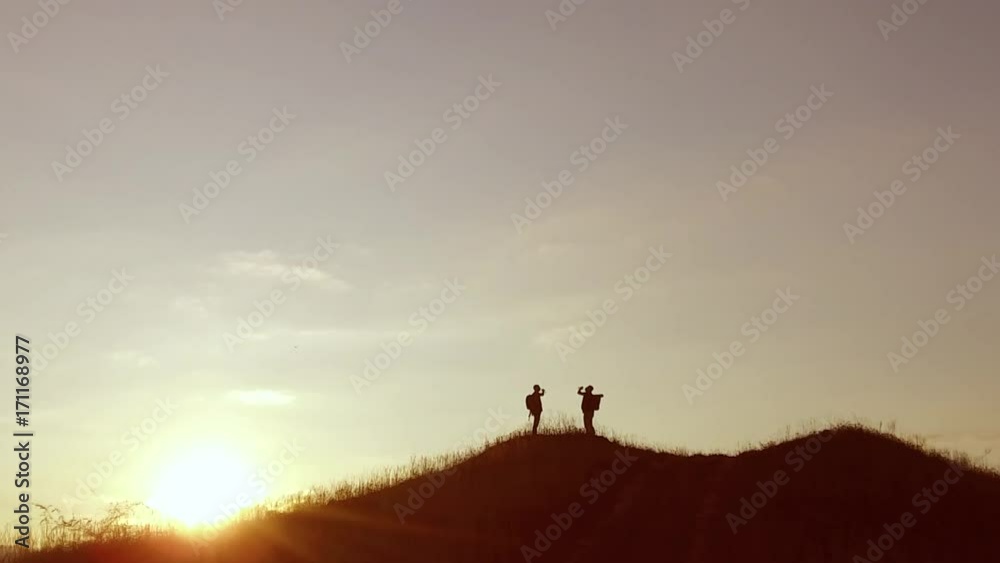 people group of tourists walking travel on top of a sunset silhouette mountain. slow video tourists people group go nature people group of tourists walking travel on top of a sunset silhouette mountain. slow video tourists people group go nature