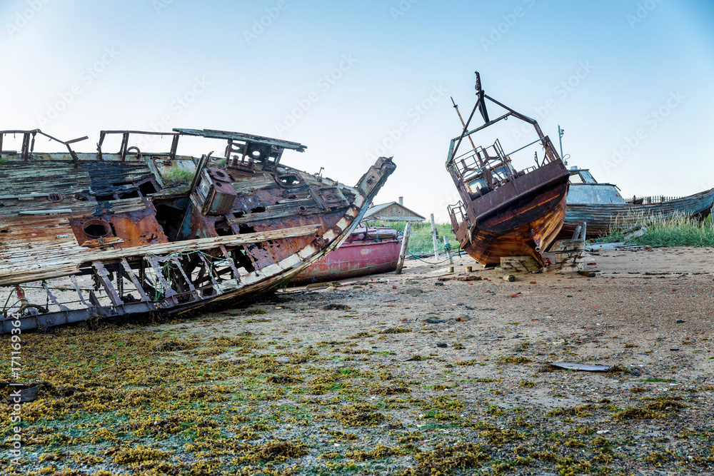 an abandoned rusty ship on a sandy beach