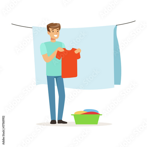 Young smiling man hanging wet clothes out to dry, house husband working at home vector Illustration