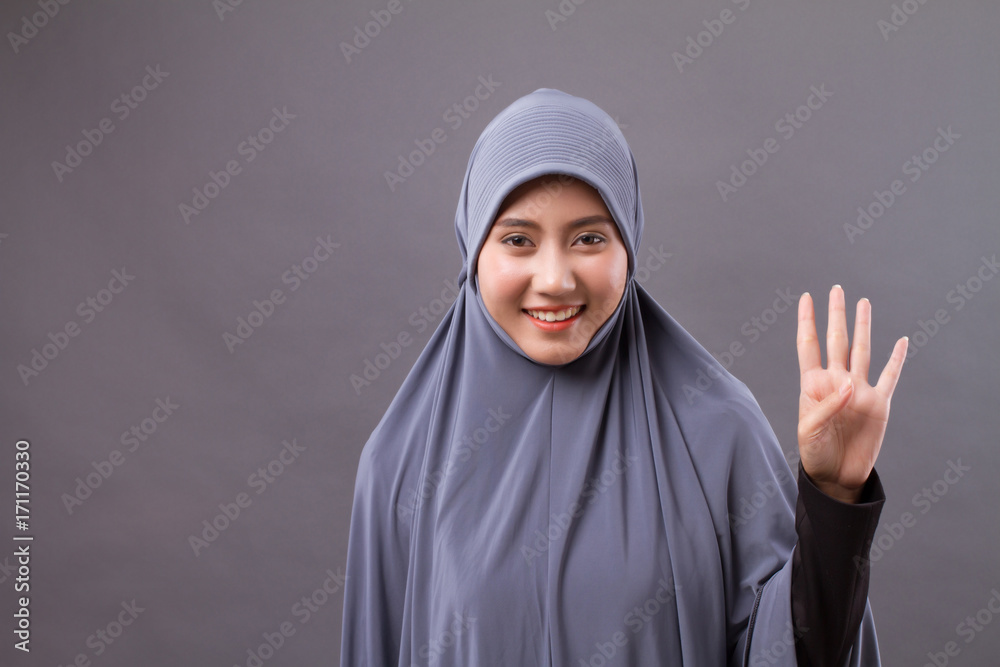 woman pointing number 4 up, asian muslim woman model