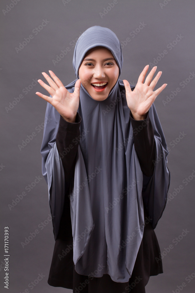 exited, surprised, happy, laughing muslim woman with hijab or head scarf exited, surprised, happy, laughing muslim woman with hijab or head scarf
