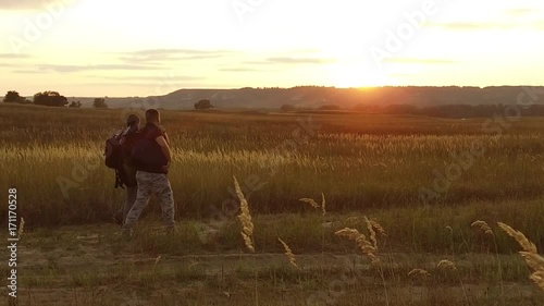 Wallpaper Mural two tourists silhouettes. nature two tourists go at sunset. tourist silhouette nature slow motion video Torontodigital.ca